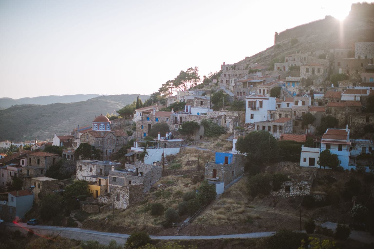 Photograph of a hillside town of stone houses above a valley