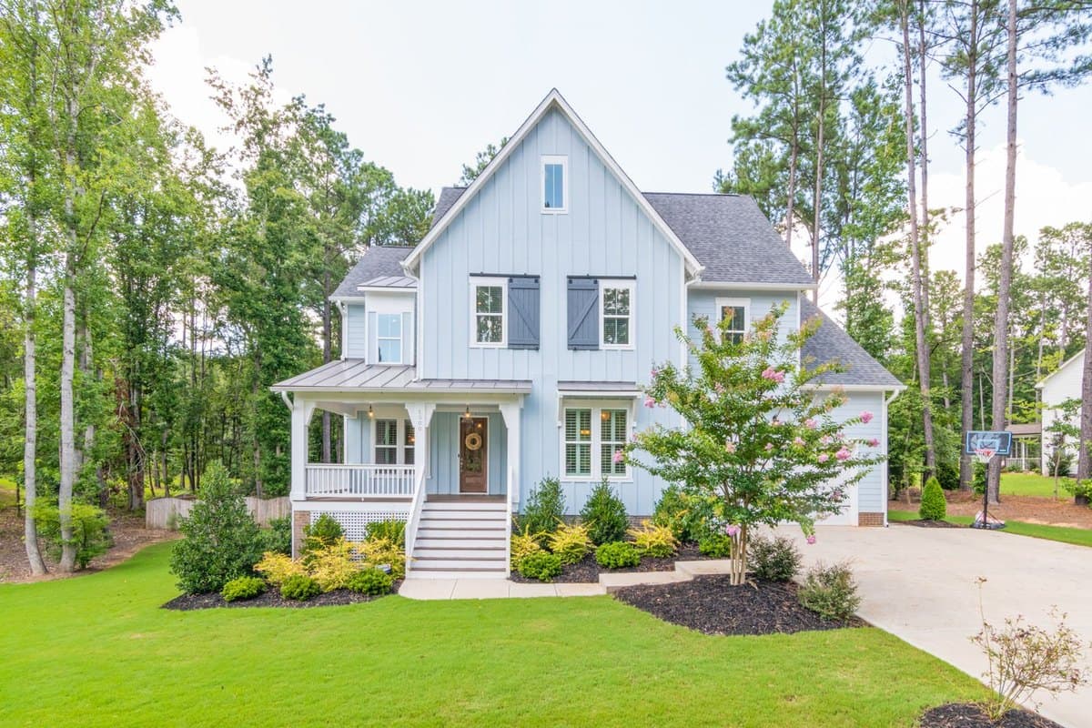 Photograph of a white two-storey house with a front porch