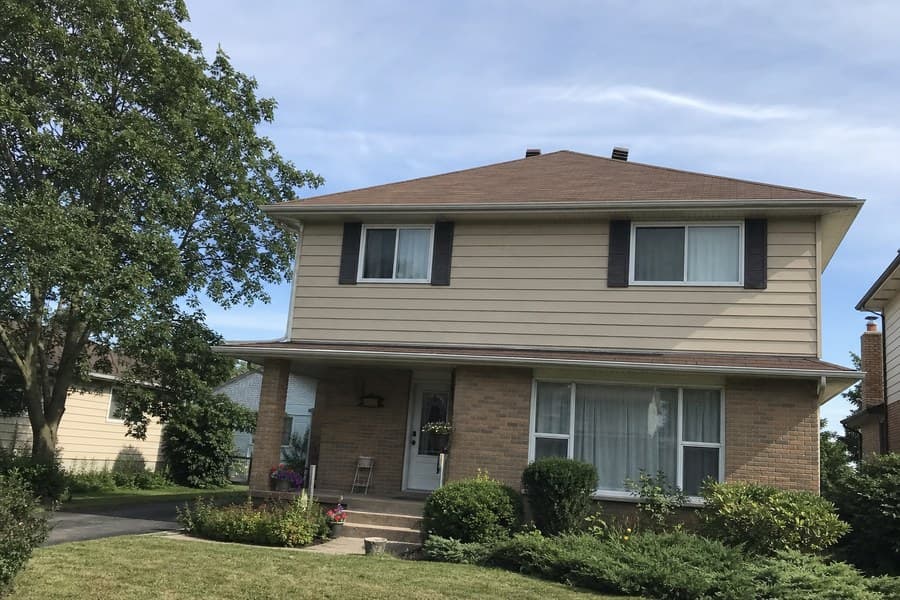 Photo of a two-storey suburban house from the street on a summer afternoon