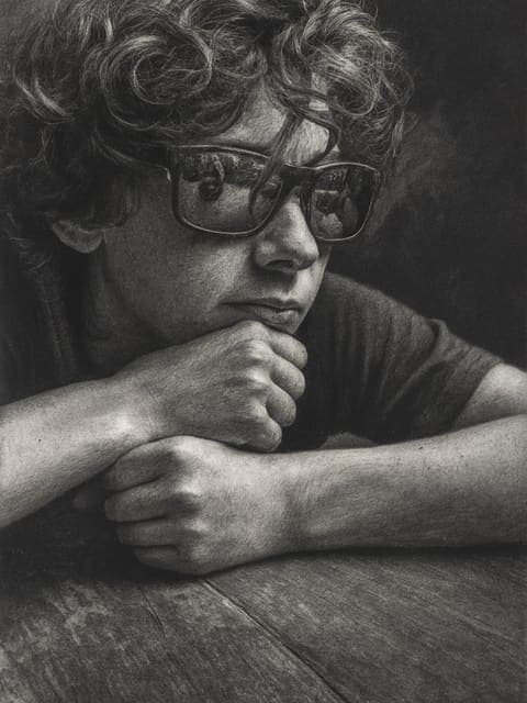 Charcoal drawing of a boy resting his chin on his hands