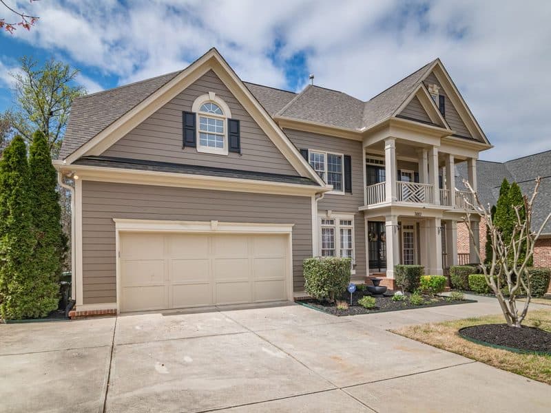 Photo of a two-storey house with a covered porch and a double garage
